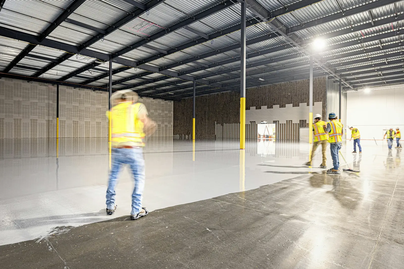 Workers on a newly finished polished warehouse floor
