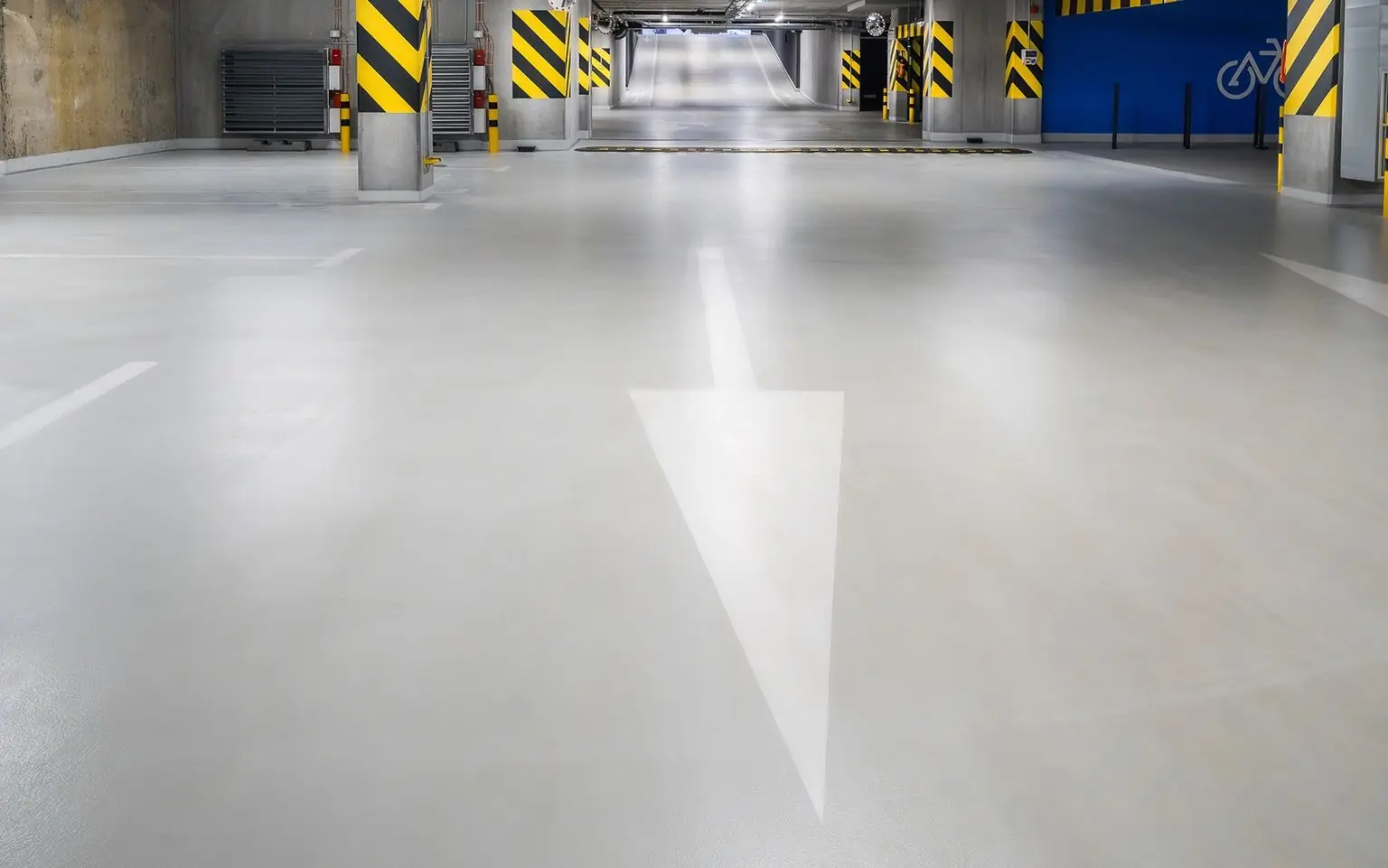 Parking garage floor with a painted direction arrow