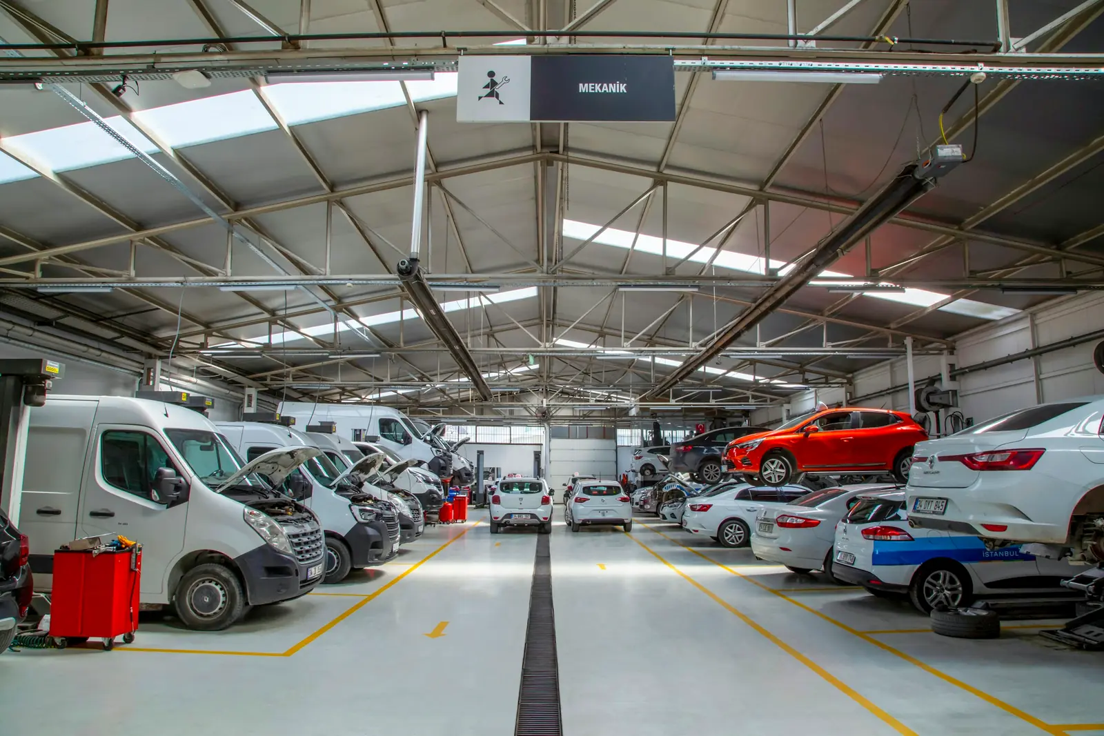 Auto service centre with vehicles on a light coated floor