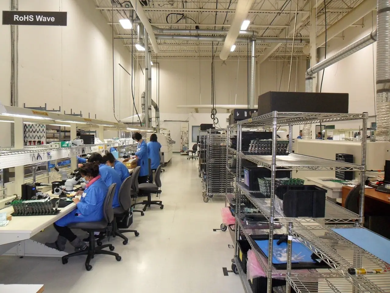 Clean production room with technicians at workstations