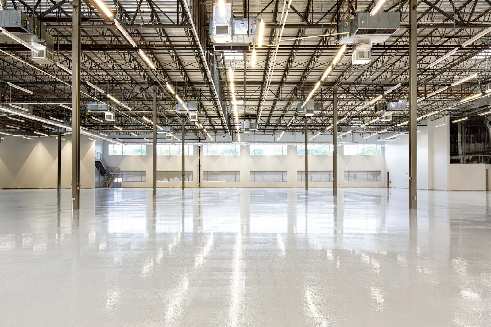 Bright warehouse with a freshly coated glossy grey floor