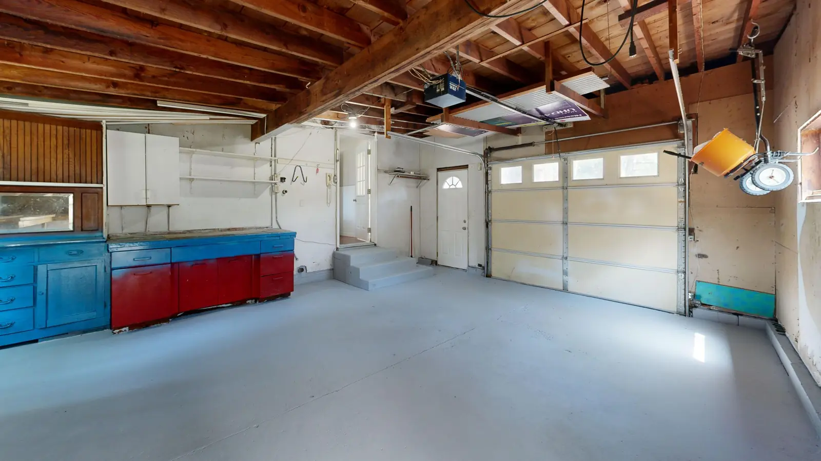 Spacious home garage with a light grey coated floor